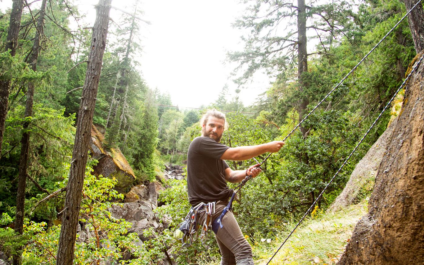 man rock climbing in forest
